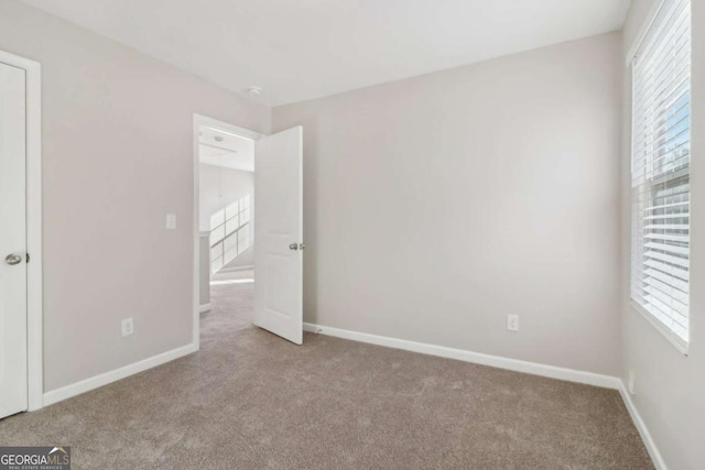 unfurnished bedroom featuring light carpet