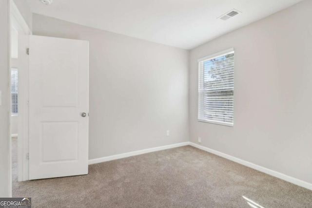 unfurnished room with light colored carpet