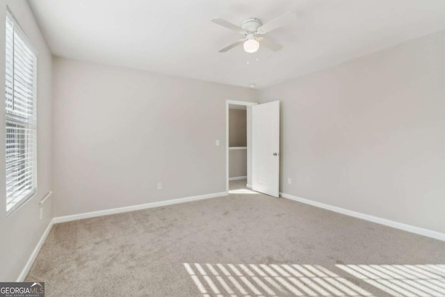 empty room with light carpet and ceiling fan