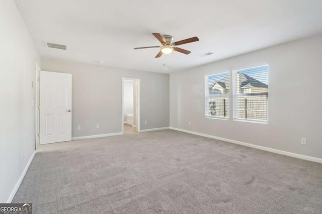 carpeted spare room featuring ceiling fan