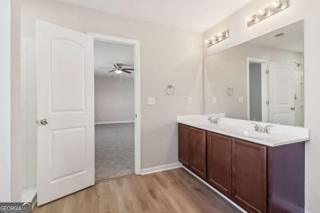 bathroom with vanity, ceiling fan, and wood-type flooring