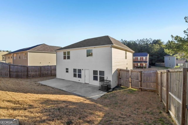 rear view of house featuring a patio, cooling unit, and a yard