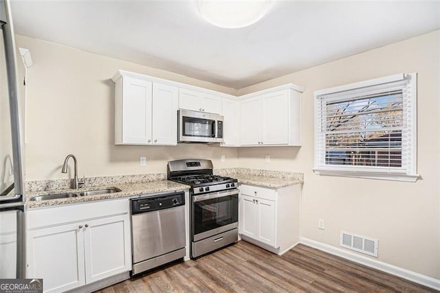 kitchen featuring sink, white cabinetry, and appliances with stainless steel finishes