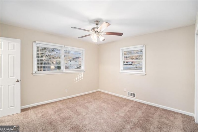 unfurnished room featuring light carpet and ceiling fan