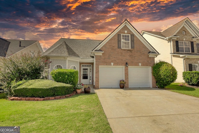 view of front of house featuring a garage and a lawn