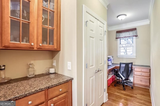 office area featuring light hardwood / wood-style flooring and crown molding