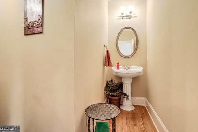 bathroom with hardwood / wood-style floors