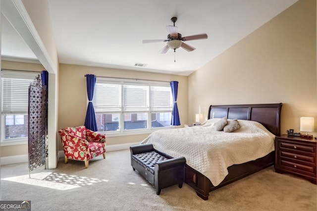 carpeted bedroom with ceiling fan and lofted ceiling