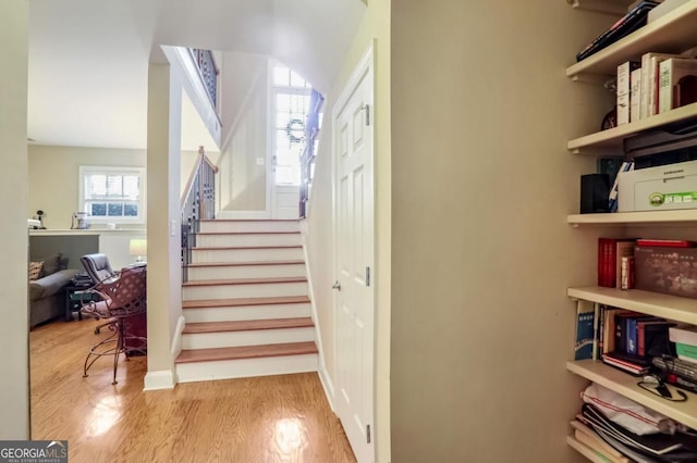 stairs with hardwood / wood-style flooring