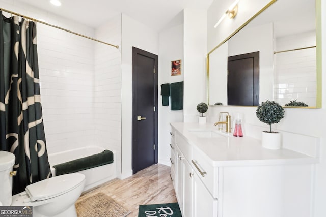 full bathroom with hardwood / wood-style floors, toilet, vanity, and shower / tub combo