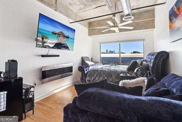 bedroom with ceiling fan and light hardwood / wood-style floors