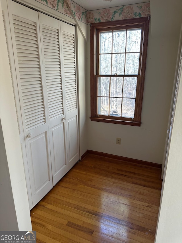 unfurnished bedroom featuring a closet and light hardwood / wood-style flooring