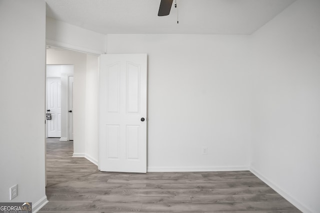 empty room featuring wood-type flooring and ceiling fan