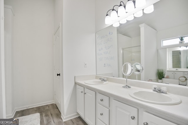 bathroom featuring vanity, an enclosed shower, and hardwood / wood-style flooring