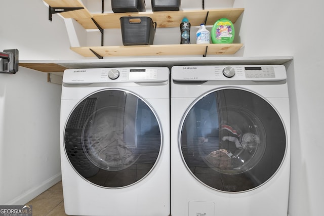 washroom with independent washer and dryer and light tile patterned flooring