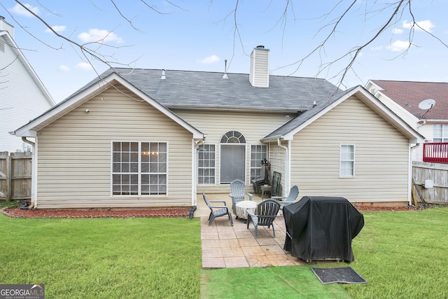 rear view of property featuring a yard and a patio