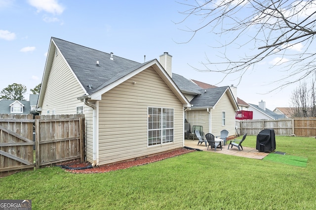 back of property featuring a lawn and a patio