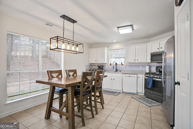 kitchen featuring sink, stainless steel appliances, and white cabinets