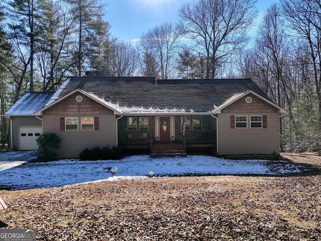 single story home featuring covered porch and a garage