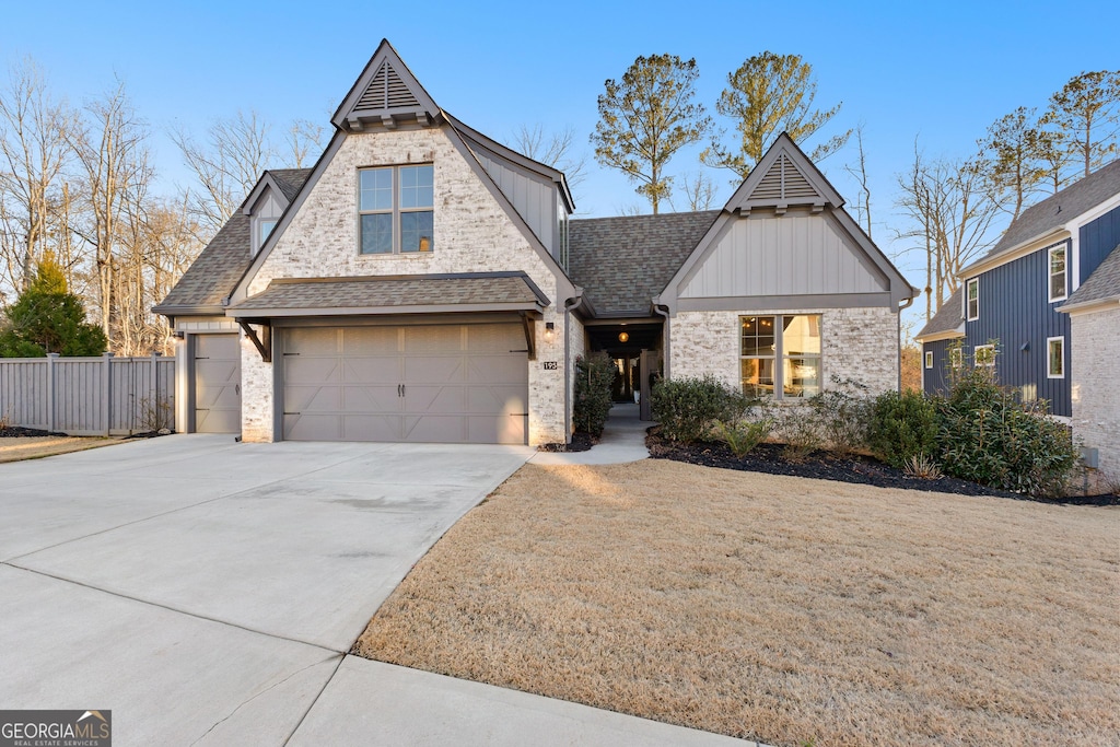 view of front of property with a garage and a front lawn