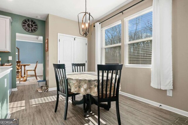 dining room featuring hardwood / wood-style floors, a tray ceiling, and a chandelier