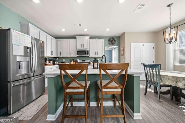 dining room with a notable chandelier and hardwood / wood-style floors