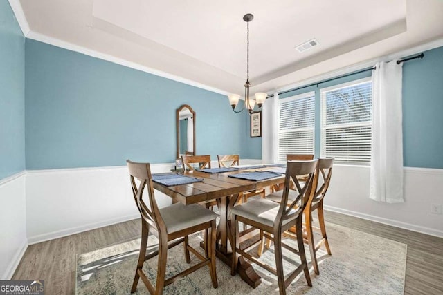 kitchen with hardwood / wood-style floors, white cabinetry, sink, an island with sink, and stainless steel appliances