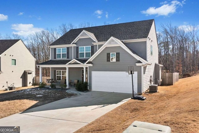 view of front facade featuring a garage, a front lawn, and a porch