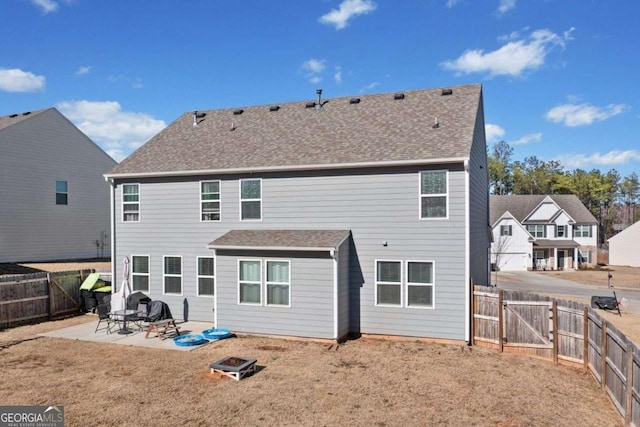 back of house with a patio area and a lawn