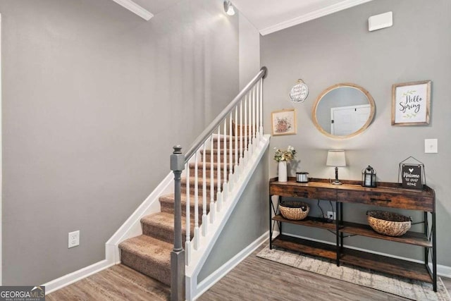 foyer entrance featuring hardwood / wood-style floors and ornamental molding