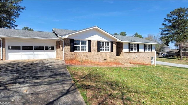 ranch-style home with a garage and a front lawn