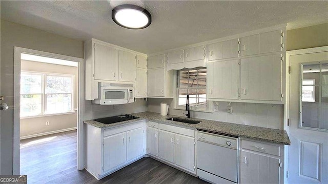 kitchen with sink, white appliances, white cabinets, and dark hardwood / wood-style floors