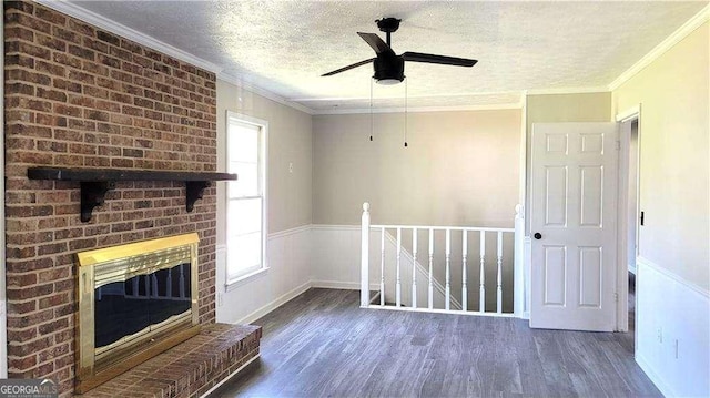 unfurnished living room featuring dark wood-type flooring, a textured ceiling, a brick fireplace, and ornamental molding