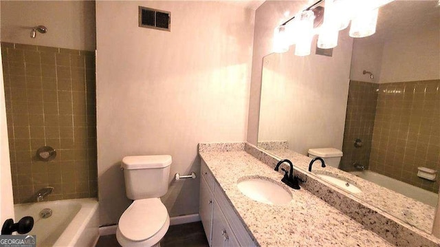 full bathroom with vanity, toilet, and tiled shower / bath combo