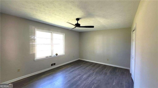 empty room with a textured ceiling, ceiling fan, and dark hardwood / wood-style flooring