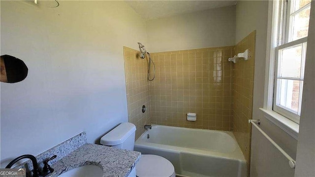 full bathroom featuring sink, toilet, and tiled shower / bath