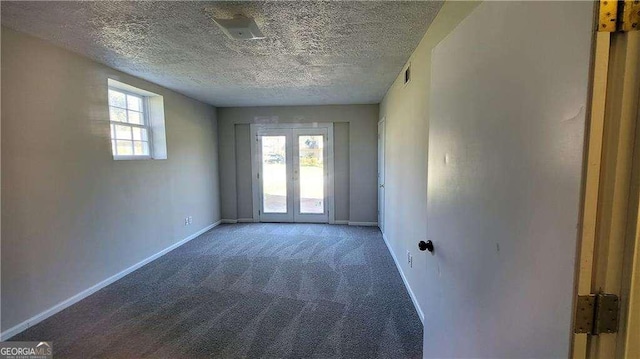 carpeted spare room with a textured ceiling