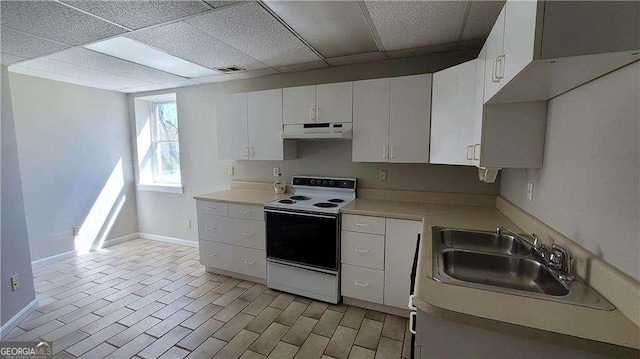 kitchen featuring white cabinets, white electric stove, a paneled ceiling, and sink