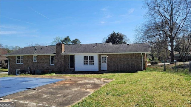 back of property featuring a patio area and a yard