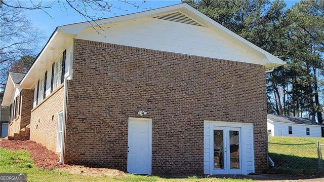 view of side of home with a lawn