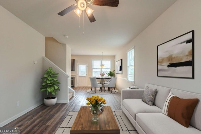 living room with ceiling fan and dark hardwood / wood-style floors