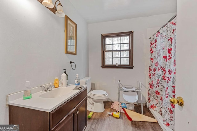 bathroom featuring vanity, toilet, hardwood / wood-style floors, and a shower with shower curtain