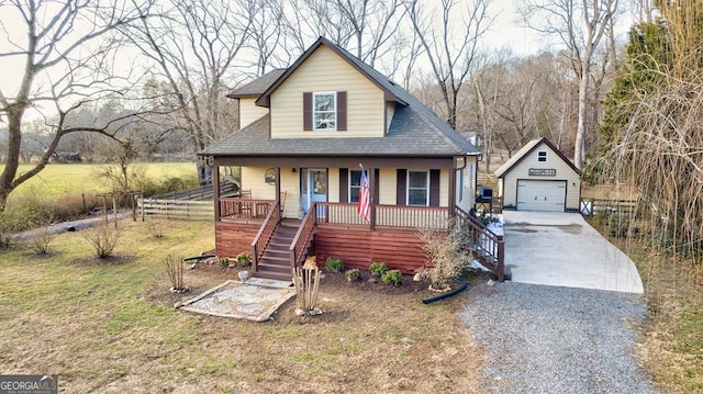 bungalow featuring a front yard, an outdoor structure, a porch, and a garage