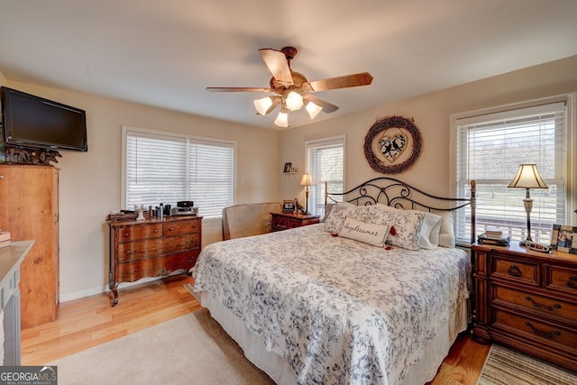 bedroom with light wood-type flooring and ceiling fan