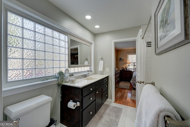 bathroom with vanity, a healthy amount of sunlight, and tile patterned flooring