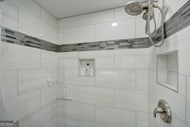 bathroom with a tile shower