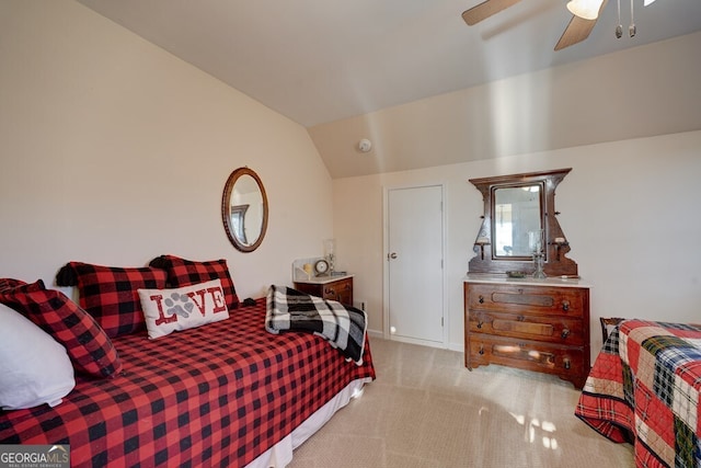 carpeted bedroom with ceiling fan and vaulted ceiling