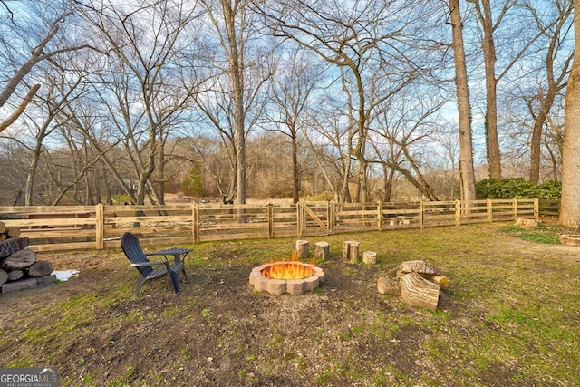 view of yard featuring an outdoor fire pit