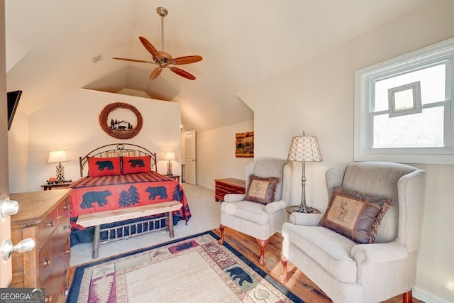 carpeted bedroom with vaulted ceiling and ceiling fan