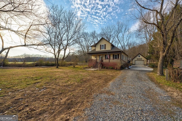 view of front of home with covered porch, an outdoor structure, and a garage